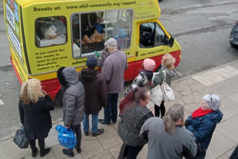 People queue at the converted ice-cream van run by New Beginnings Improving Lives