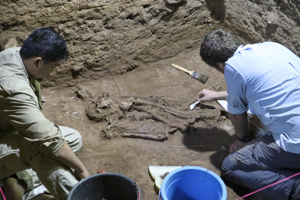 Dr Tim Maloney and Andika Priyatno work at the site in a cave in East Kalimantan, Borneo, Indonesia, March 2, 2020. The remains, which have been dated to 31,000 years old, mark the oldest evidence for amputation yet discovered. And the prehistoric “surgery” could show that humans were making medical advances much earlier than previously thought, according to the study published Wednesday, Sept. 7, 2022 in the journal Nature. (Tim Maloney/Griffith University via AP)