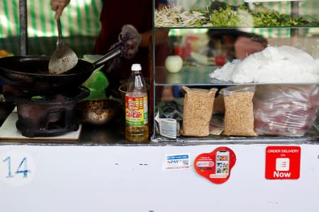 Mobile e-payment logos are see in an street food stall in Ho Chi Minh city in Vietnam