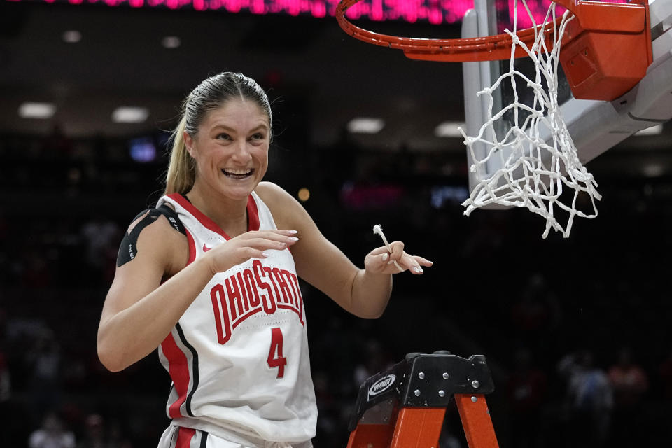 Ohio State guard Jacy Sheldon smiles after cutting off a piece of the net following Ohio State's win over Michigan in an NCAA college basketball game to claim the regular-season Big Ten title, Wednesday, Feb. 28, 2024, in Columbus, Ohio. (AP Photo/Sue Ogrocki)