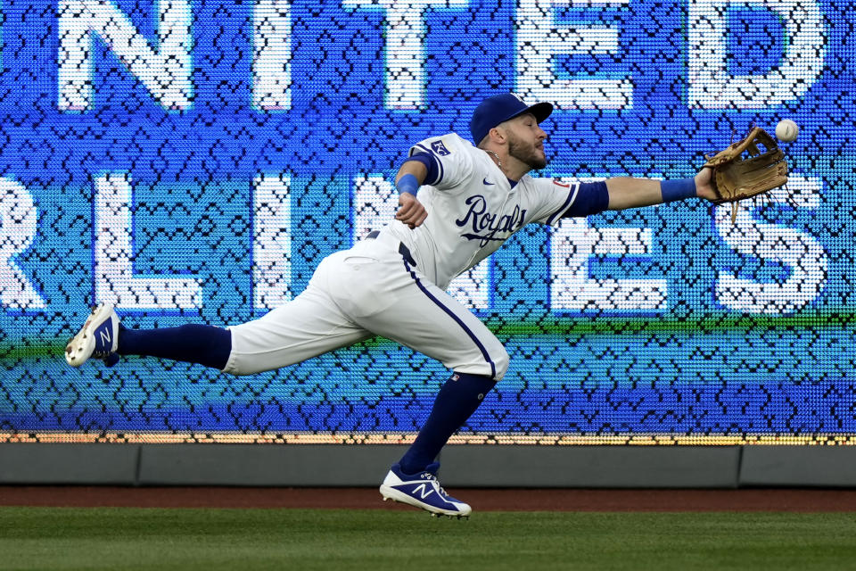 Kansas City Royals center fielder Garrett Hampson can't reach a three-run triple hit by Bo Bichette during the third inning of a baseball game Monday, April 22, 2024, in Kansas City, Mo. (AP Photo/Charlie Riedel)