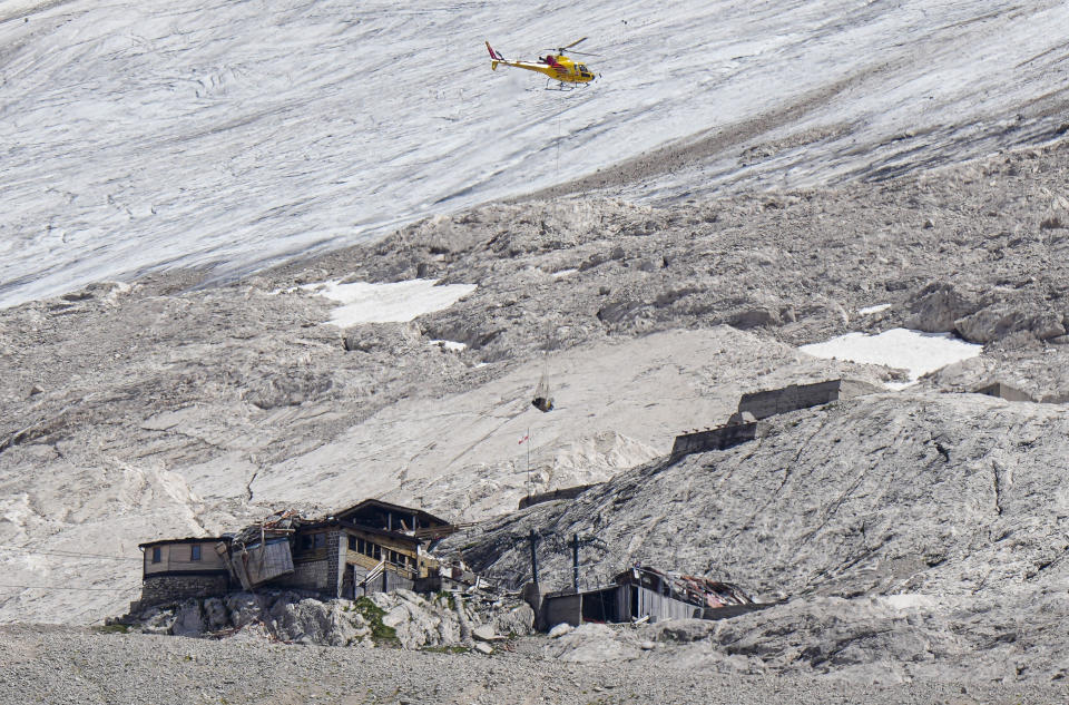 A rescue helicopter brings technical support on the Punta Rocca glacier near Canazei in northern Italy