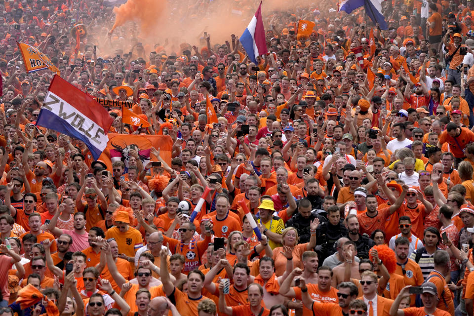 Fans of the team of the Netherlands walk towards the stadium ahead of a semifinal match between the Netherlands and England at the Euro 2024 soccer tournament in Dortmund, Germany, Wednesday, July 10, 2024. (AP Photo/Markus Schreiber)