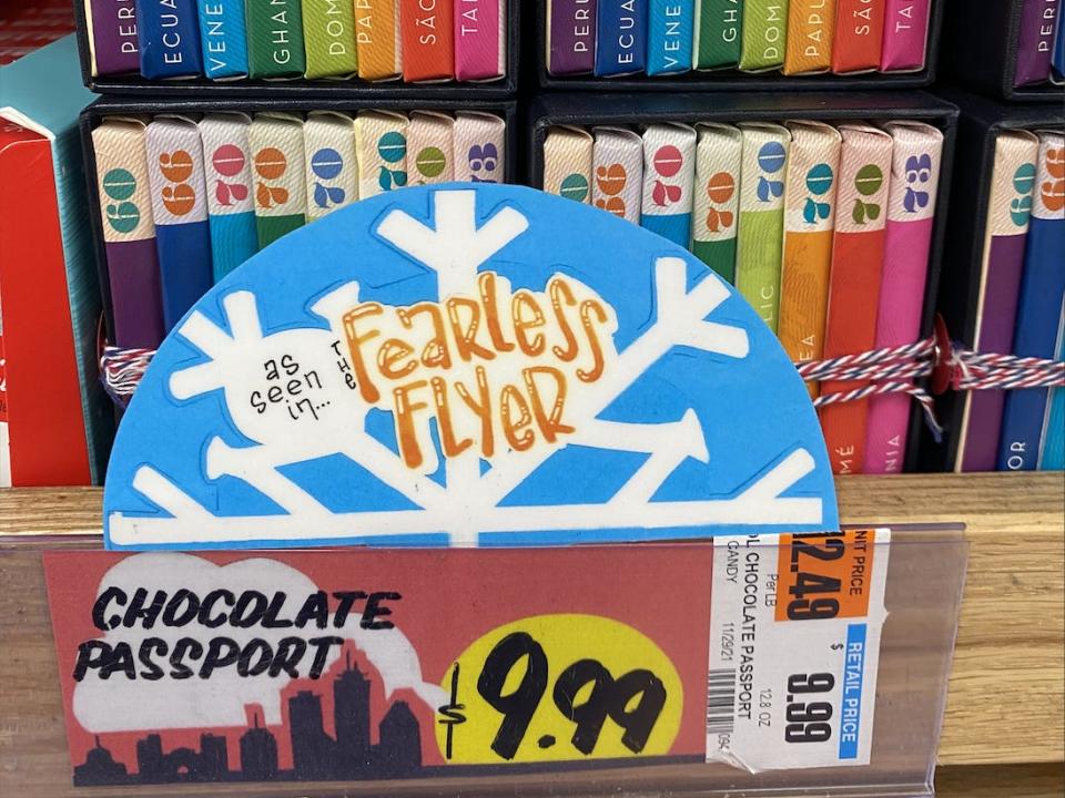 colorful chocolate passports on a shelf with blue-and-red $9.99 price tag at Trader Joe's