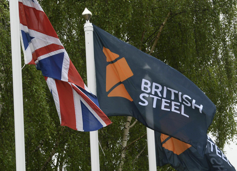 FILE - This June 1, 2016 file photo shows a flag with a British Steel logo at the entrance to the steelworks plant in Scunthorpe, England, now owned by British Steel. Britain’s government pledged Tuesday May 21, 2019 to do its utmost to support British Steel amid reports the company is facing bankruptcy. (Anna Gowthorpe/PA via AP)