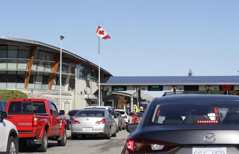 In this Oct. 9, 2019 photo, traffic enters Canada from the United States at the Peace Arch Border Crossing, in Blaine, Wash. The Washington state chapter of the Council on American-Islamic Relations says more than 60 Iranians and Iranian-Americans were detained and questioned at the border crossing over the weekend. A U.S. Customs and Border Protection spokesman, however, said no Iranian-Americans were detained or refused entry because of their country of origin. (AP Photo/Elaine Thompson)