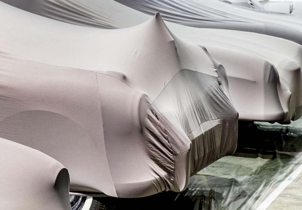 Cars are covered ahead of the start of the IAA Auto Show in Frankfurt, Germany, Sunday, Sept. 8, 2019. (AP Photo/Michael Probst)