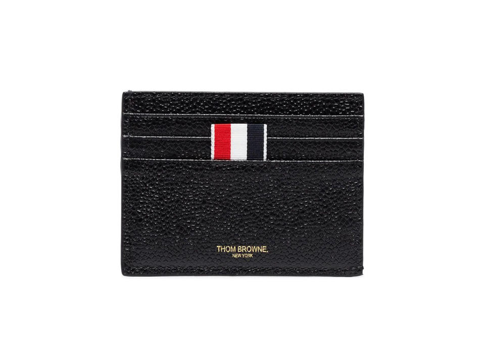 https://prf.hn/click/camref:1011liuTL/pubref:THR--mensgiftsspring2022/destination:https://www.farfetch.com/shopping/men/thom-browne-card-holder-with-note-compartment-in-black-pebble-grain-item-11527226.aspx?storeid=10552