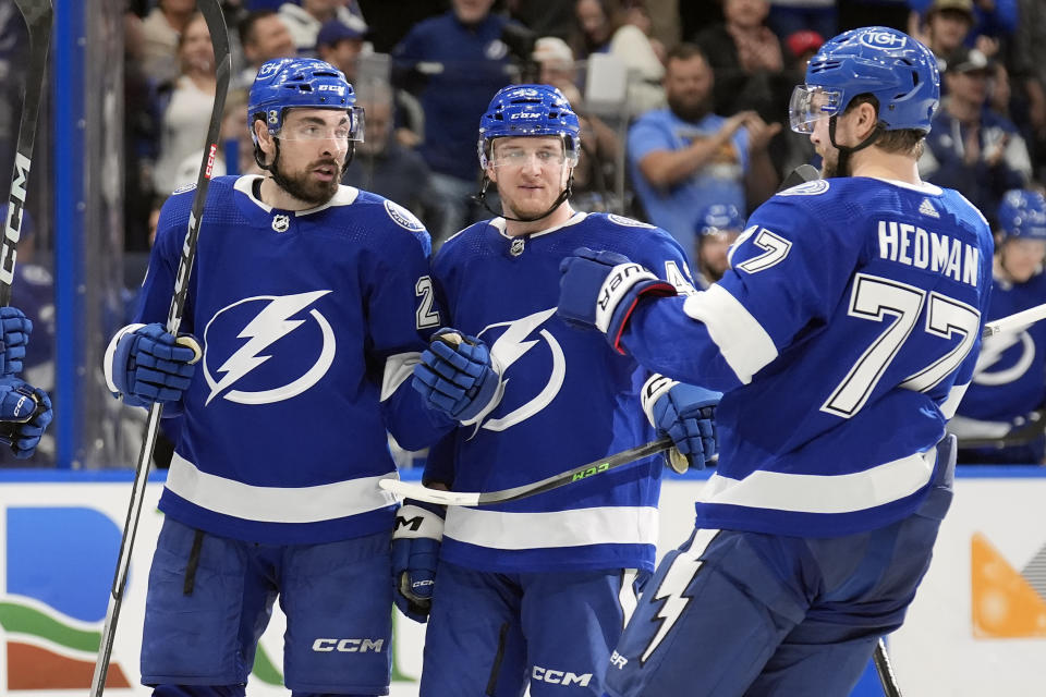 Tampa Bay Lightning left wing Nicholas Paul (20) celebrates his goal against the New Jersey Devils with defenseman Darren Raddysh (43) and defenseman Victor Hedman (77) during the second period of an NHL hockey game Saturday, Jan. 27, 2024, in Tampa, Fla. (AP Photo/Chris O'Meara)