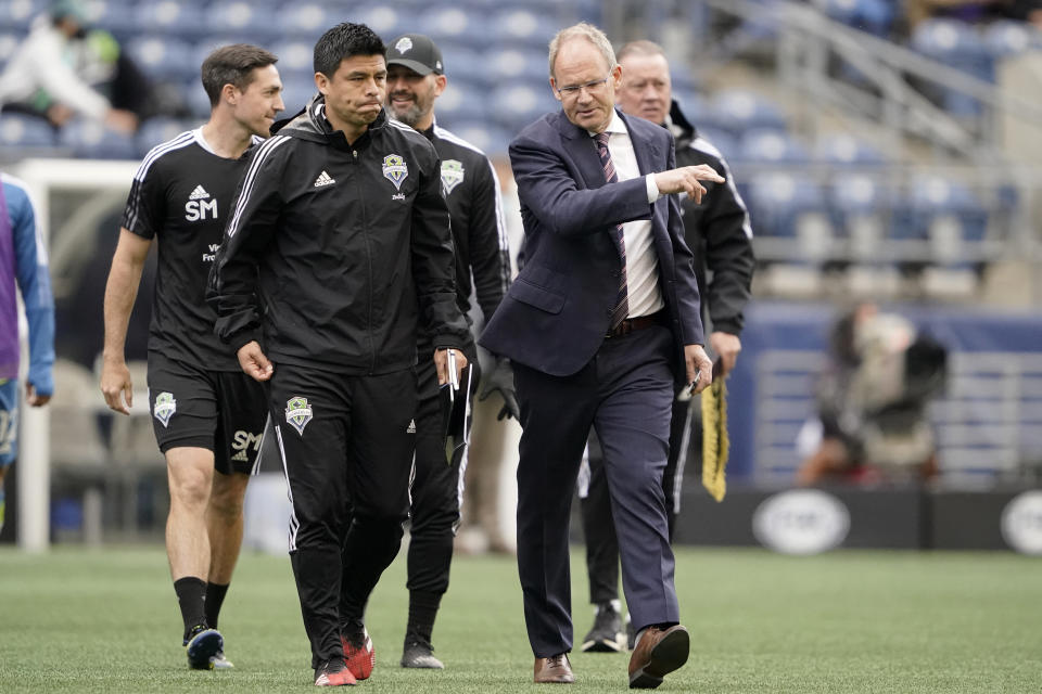 FILE - Seattle Sounders head coach Brian Schmetzer, front right, walks with assistant coach Gonzalo Pineda, second from left, after the first half of an MLS soccer match against Atlanta United in Seattle, in this Sunday, May 23, 2021, file photo. Former Mexican national team player Gonzalo Pineda was hired Thursday, Aug. 12, 2021, as head coach of Atlanta United and tasked with stabilizing a team that's seen plenty of turnover at the coaching position.(AP Photo/Ted S. Warren)