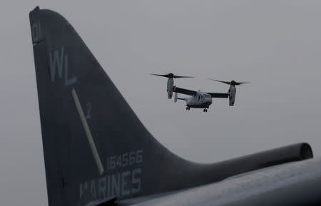 FILE PHOTO - A U.S. Marines MV-22 Osprey Aircraft flies over a jet before landing on the deck of the USS Bonhomme Richard amphibious assault ship off the coast of Sydney, Australia June 29, 2017. REUTERS/Jason Reed/File Photo