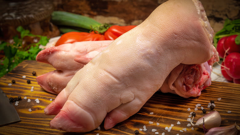 raw pig feet on cutting board