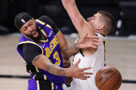 Los Angeles Lakers' Anthony Davis (3) passes the ball around Denver Nuggets' Nikola Jokic (15) during the second half of an NBA conference final playoff basketball game Saturday, Sept. 26, 2020, in Lake Buena Vista, Fla. (AP Photo/Mark J. Terrill)