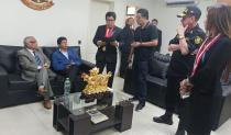 In this photo provided by Peru's police administration office, former President Pedro Castillo, second from left, and former Prime Minister Anibal Torres, far left, sit as prosecutor Marco Huaman stands at center inside a police station, where Castillo and Torres' status was not immediately clear, in Lima, Peru, Wednesday, Dec. 7, 2022. Peru’s Congress removed Castillo from office Wednesday and replaced him with the vice president, shortly after the president decreed the dissolution of the legislature ahead of a scheduled vote to oust him. (Peru's police administration office via AP)