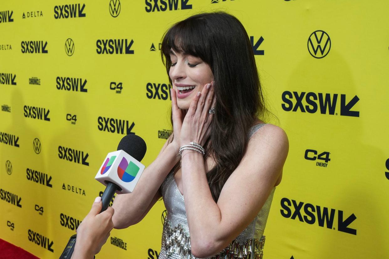 Anne Hathaway reacts to fans cheering as she speaks to the media at the premiere of "The Idea of You" at SXSW on March 16, 2024.
