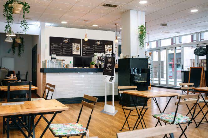 A small cafe is empty and ready for coffee drinkers.