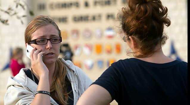 Krystina Cassidy, left, and Dianna Simpson attempt to make contact with their husbands who are stationed inside Fort Hood while standing outside of the Bernie Beck Gate. Photo: AP