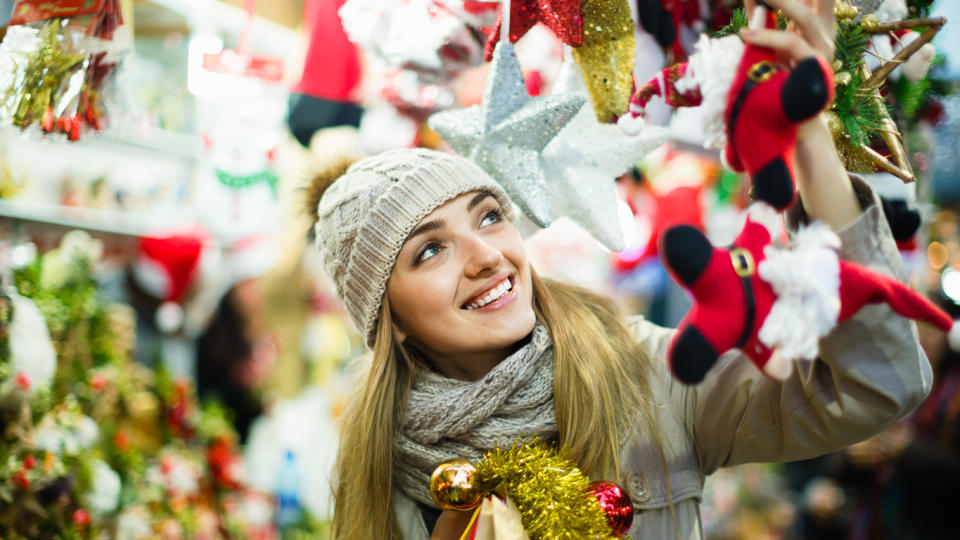 smiling woman under christmas decorations