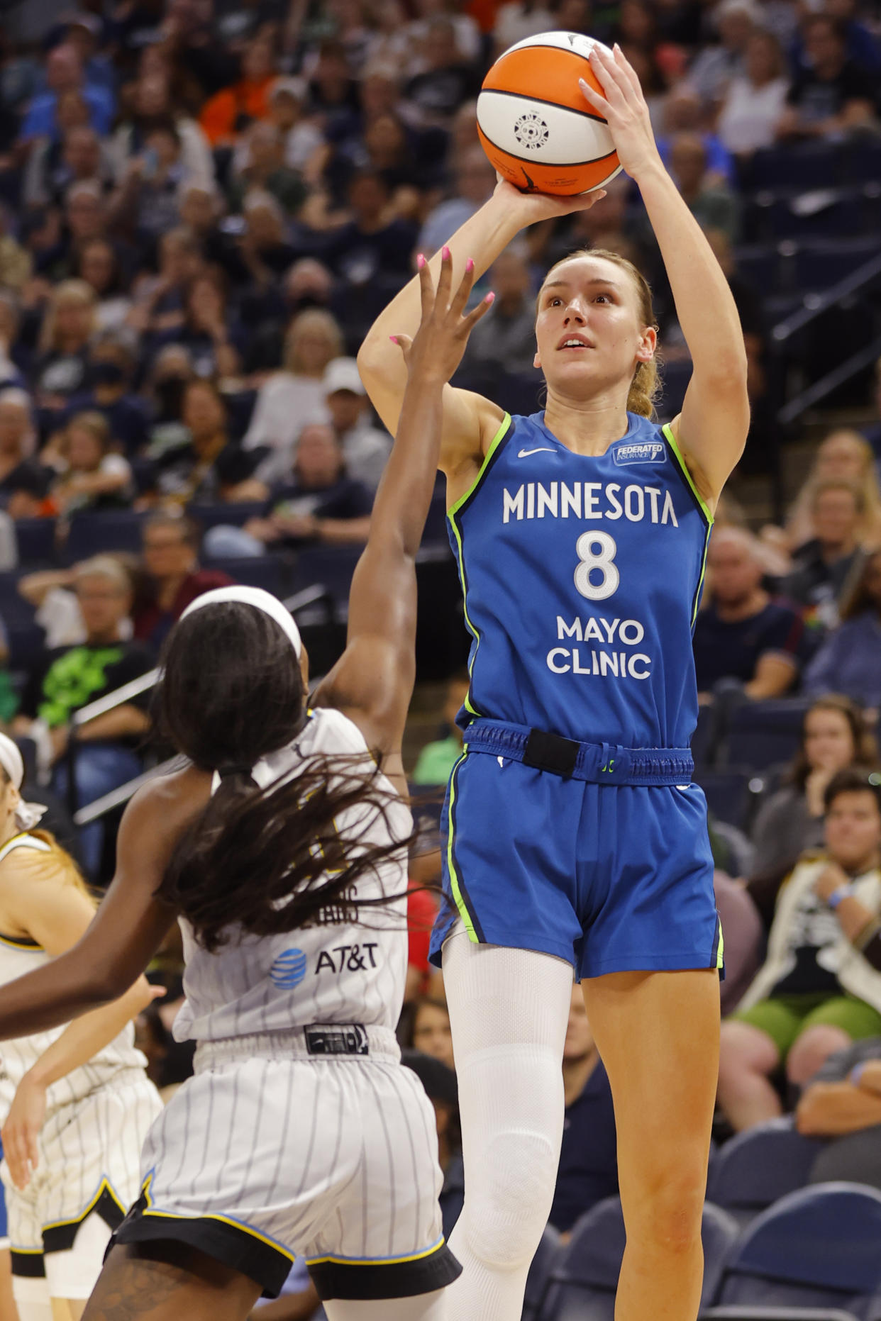 Minnesota Lynx forward Alanna Smith (8) shoots over Chicago Sky guard Dana Evans (11) in the second quarter of a WNBA basketball game, Friday, Sept. 13, 2024, in Minneapolis. (AP Photo/Bruce Kluckhohn)