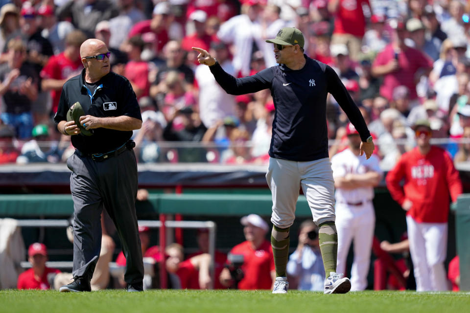 CINCINNATI, OH - MAY 21: New York Yankees manager Aaron Boone argues with Governor Brian Onuora after being ejected in the first half against the Cincinnati Reds at Great American Ball Park on May 21, 2023 in Cincinnati, Ohio.  (Photo by Dylan Boyle/Getty Images)