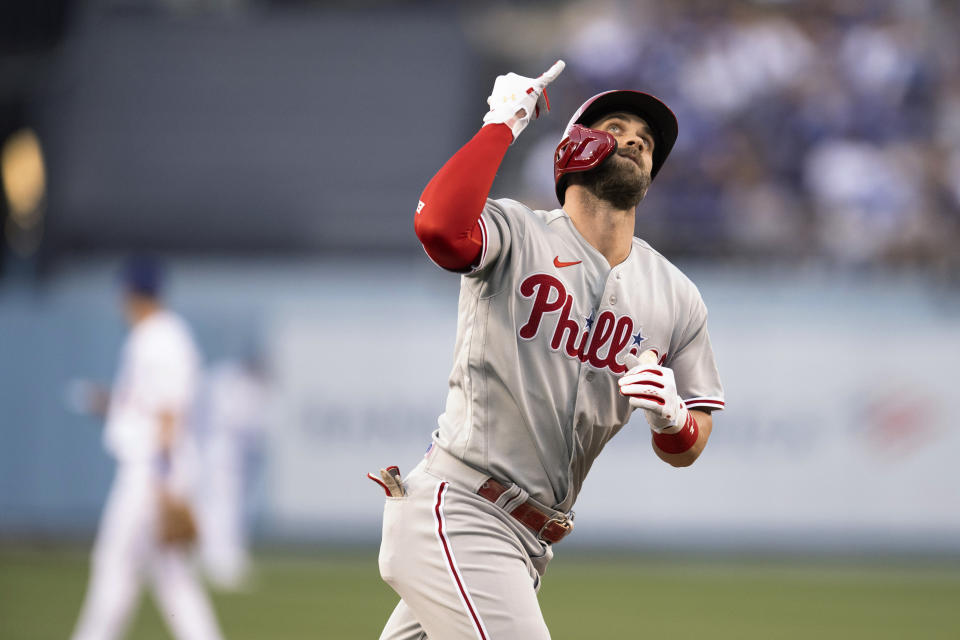 Philadelphia Phillies' Bryce Harper celebrates his solo home run against the Los Angeles Dodgers during the first inning of a baseball game in Los Angeles, Thursday, May 12, 2022. (AP Photo/Kyusung Gong)