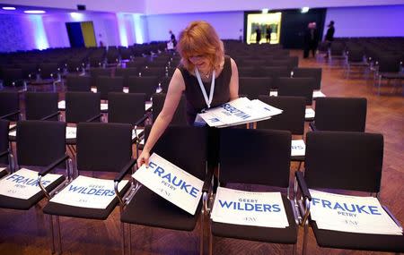 An assistant prepares placards with the names of Germany's Alternative for Germany (AfD) leader Frauke Petry and Netherlands' Party for Freedom (PVV) leader Geert Wilders before the start of a European far-right leaders meeting to prepare upcoming elections in Europe, in Koblenz, Germany, January 21, 2017. REUTERS/Wolfgang Rattay