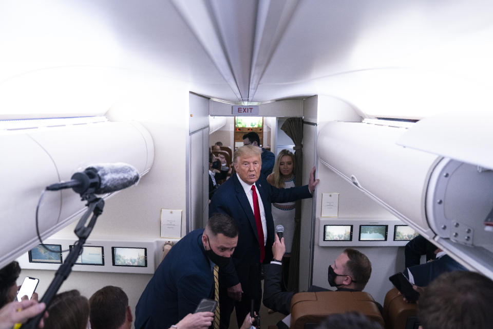 President Donald Trump talks with reporters after leaving a campaign rally at Pensacola International Airport, Friday, Oct. 23, 2020, aboard Air Force One. (AP Photo/Evan Vucci)