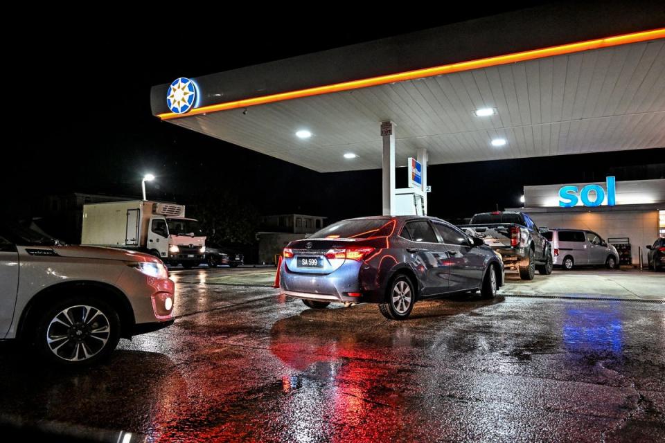 Car line up at a gas station before hurricane Beryl lands in Bridgetown, Barbados (AFP via Getty Images)