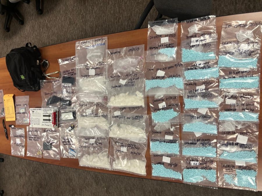 A backpack lies next to it’s contents, which included fentanyl pills and methamphetamines. Photo provided by the Adams County District Attorney’s Office.