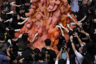 FILE - University students clean the "Pillar of Shame" statue, a memorial for those killed in the 1989 Tiananmen crackdown, at the University of Hong Kong, June 4, 2019. From the military suppression of Beijing’s 1989 pro-democracy protests to the less deadly crushing of Hong Kong’s opposition four decades later, China’s long-ruling Communist Party has demonstrated a determination and ability to stay in power that is seemingly impervious to Western criticism and sanctions. (AP Photo/Kin Cheung, File)