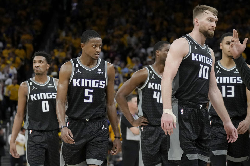 Sacramento Kings guard Malik Monk (0), guard De'Aaron Fox (5), forward Harrison Barnes, middle, forward Domantas Sabonis (10) and forward Keegan Murray (13) walk to the bench for a timeout during the second half of Game 4 in the first round of the NBA basketball playoffs against the Golden State Warriors in San Francisco, Sunday, April 23, 2023. (AP Photo/Jeff Chiu)