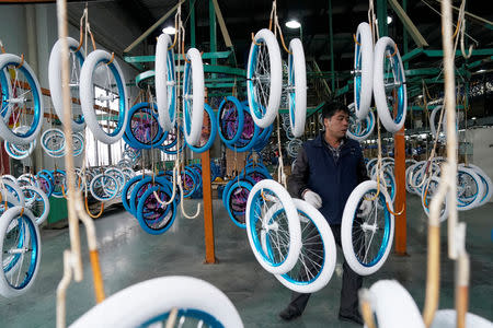 An employee works on the production line of Kent bicycles at Shanghai General Sports Co., Ltd, in Kunshan, Jiangsu Province, China, February 22, 2019. Picture taken February 22, 2019. REUTERS/Aly Song