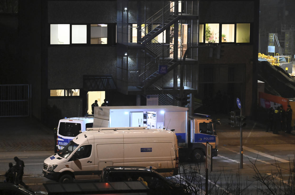 A truck of the police's explosives defusing unit stands in front of a building of Jehovah's Witnesses in Hamburg, Germany, Thursday, March 9, 2023. German police say shots were fired inside a building used by Jehovah’s Witnesses in Hamburg and an unspecified number of people were killed or wounded. The shooting took place Thursday evening in the Gross Borstel district. (Jonas Walzberg/dpa via AP)
