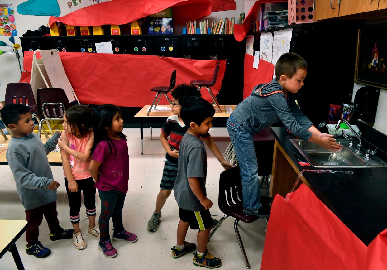 Children line up to wash hands before lunch at a day care at Martinez Elementary School in Abilene, Texas, on April 1, 2020. The child care is organized by United Way of Abilene and is provided at no cost for essential workers.