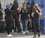 Red Bull driver Sergio Perez, of Mexico, right, smiles upon his arrival for the first day of the Formula One Mexico Grand Prix at the Hermanos Rodriguez racetrack in Mexico City, Thursday, Oct. 27, 2022. (AP Photo/Moises Castillo)