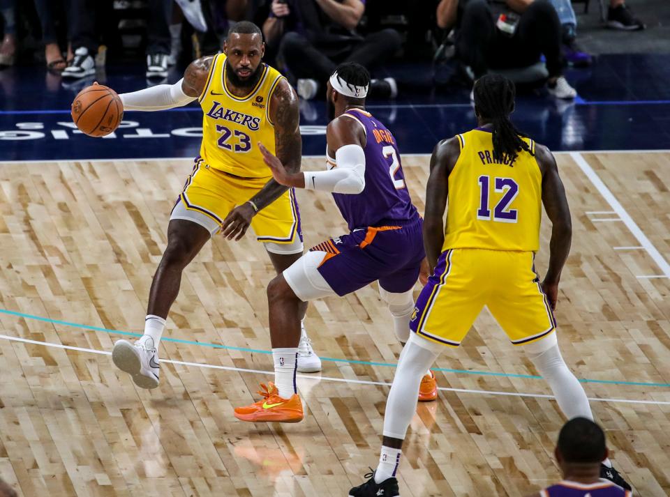 Los Angeles Lakers forward LeBron James (23) takes the ball down the court guarded by Phoenix Suns guard Josh Okogie (2) during the first quarter of their preseason game at Acrisure Arena in Palm Desert, Calif., Thursday, Oct. 19, 2023.