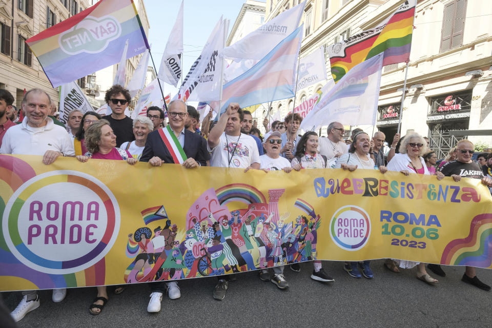 Rome Mayor Roberto Gualtieri, wearing the three color band of the Italian flag, joins the LGBTQ+ Pride parade in Rome, Saturday, June 10, 2023. Rome's annual LGBTQ+ Pride parade is winding its way through the Italian capital. This year's version provides a counterpoint to the right-wing national government's crackdown on surrogate pregnancies. Earlier this year, the government headed by far-right Premier Giorgia Meloni told municipal officials to refrain from recording both members of a same-sex couple as the parent of the child, only the biological parent. Among those who have defied that order was center-left Rome Mayor Roberto Gualtieri, who came to Saturday's parade. (Mauro Scrobogna/LaPresse via AP)