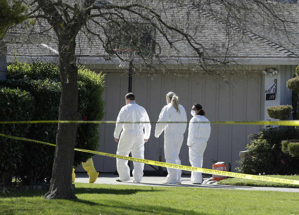 FILE - In this Thursday, March 23, 2017 file photo, investigators walk to the home where four people were found dead in Sacramento, Calif. A suspect is being held in San Francisco. The Sacramento County coroner's office on Sunday, March 26, 2017, confirmed the victims as 45-year-old Angelique Vasquez; her 14-year-old daughter, Mia Vasquez; her 11-year-old son, Alvin Vasquez; and 21-year-old Ashley Coleman. Police didn't immediately know what relationship Coleman had to the Vasquez family. (AP Photo/Rich Pedroncelli, File)