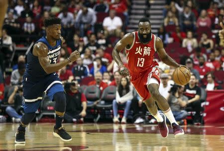 Feb 23, 2018; Houston, TX, USA; Houston Rockets guard James Harden (13) dribbles the ball on a fast break as Minnesota Timberwolves guard Jimmy Butler (23) defends during the first quarter at Toyota Center. Mandatory Credit: Troy Taormina-USA TODAY Sports