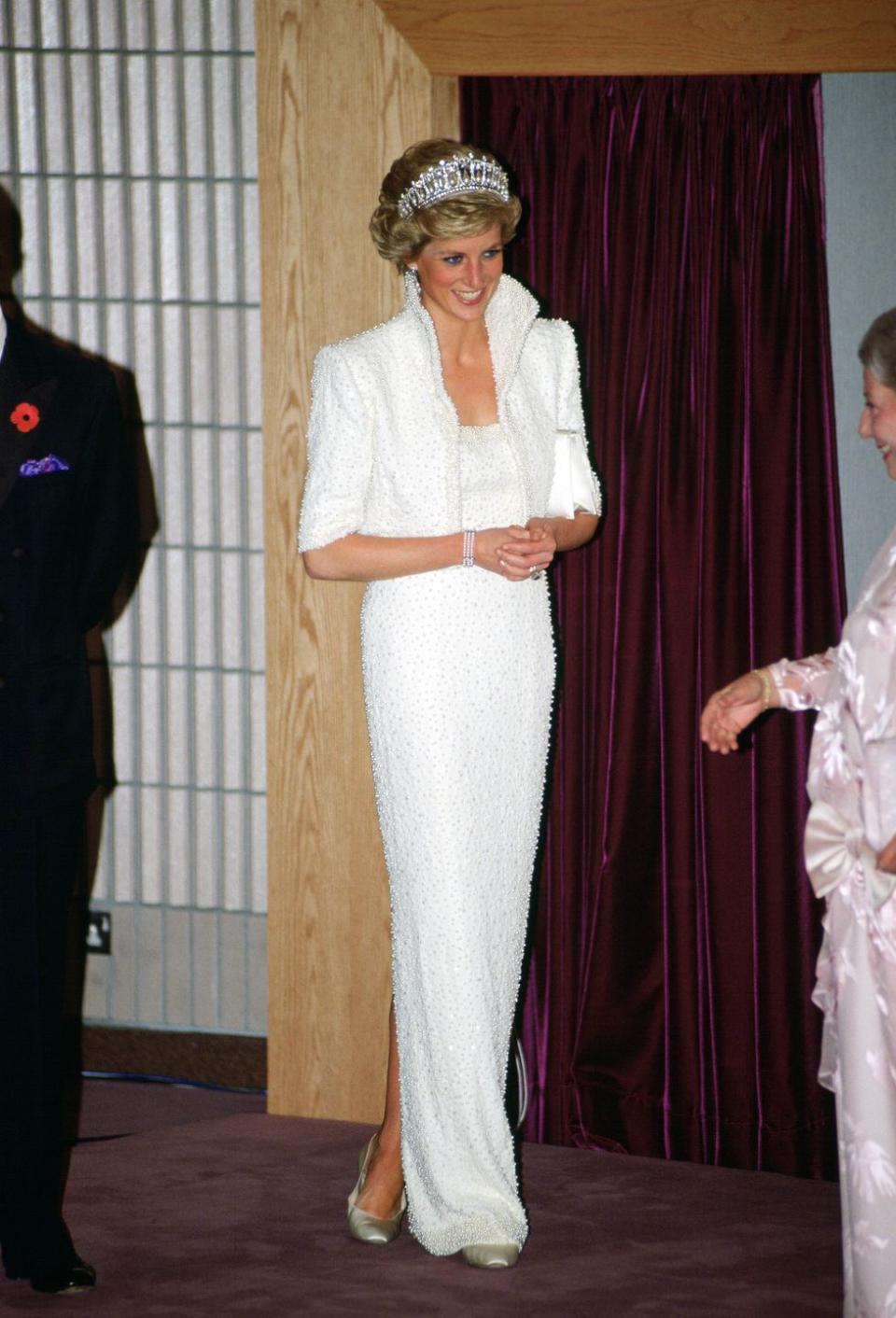 <p>During a royal visit to Hong Kong, the Princess wore a white silk dress with pearl and sequined <a href="https://collections.vam.ac.uk/item/O130882/the-elvis-dress-state-evening-ensemble-walker-catherine/" rel="nofollow noopener" target="_blank" data-ylk="slk:detailing by Catherine Walker;elm:context_link;itc:0;sec:content-canvas" class="link ">detailing by Catherine Walker</a> that is now called "The Elvis Dress" by many. </p>