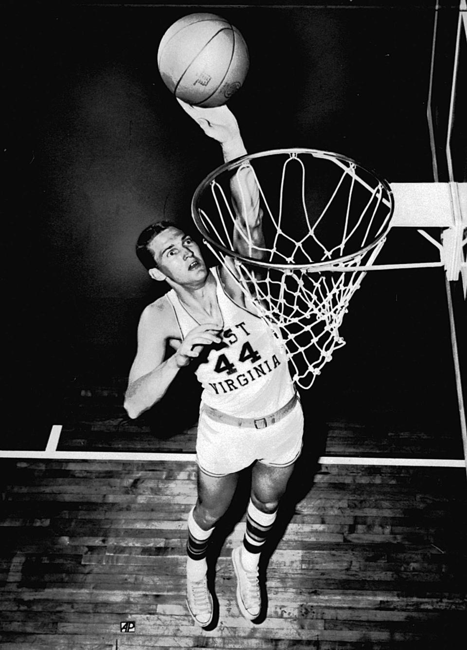 FILE - West Virginia University basketball star Jerry West takes a practice shot in 1959. Jerry West, who was selected to the Basketball Hall of Fame three times in a storied career as a player and executive and whose silhouette is considered to be the basis of the NBA logo, died Wednesday morning, June 12, 2024, the Los Angeles Clippers announced. He was 86. (AP Photo/File)