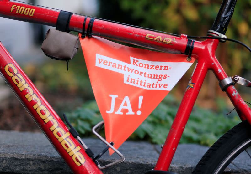 A small banner reading: "Responsible Business Initiative - Yes on November 29" is fixed to the frame of a bicycle in Zurich