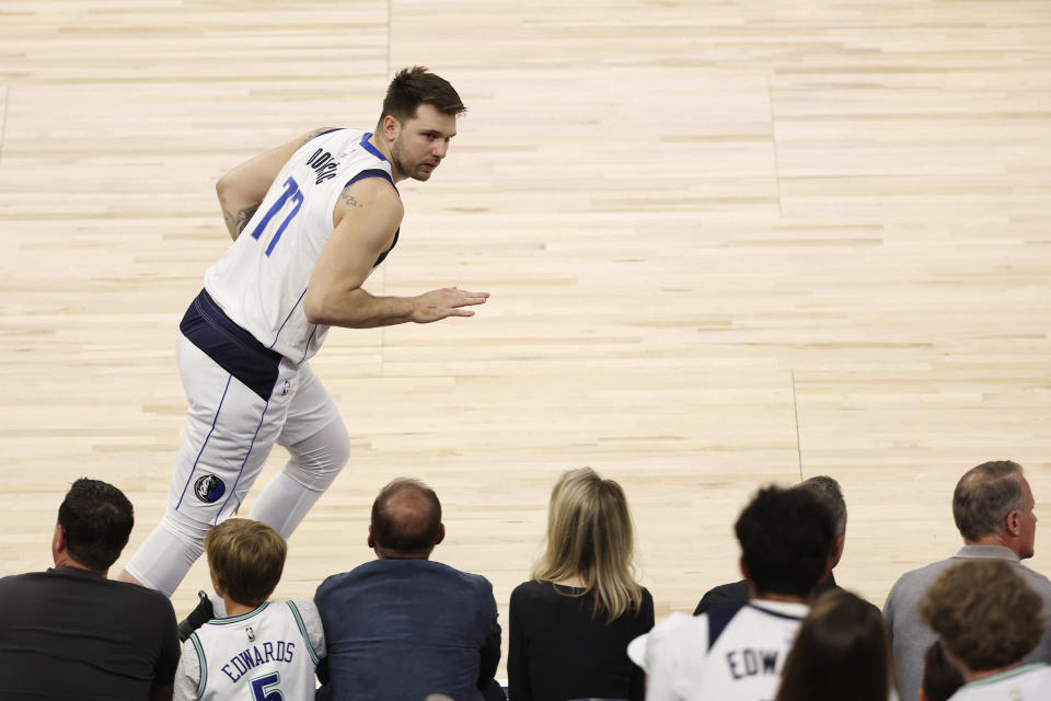 Dallas Mavericks guard Luka Doncic celebrates his made 3-pointer against the Minnesota Timberwolves during the first half of Game 5 of the Western Conference finals in the NBA basketball playoffs, Thursday, May 30, 2024, in Minneapolis. (AP Photo/Matt Krohn)