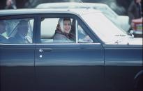 <p>Originating her pattern of wearing a headscarf while driving, the Queen drove her Vauxhall Astra estate car in Windsor Great Park.</p>