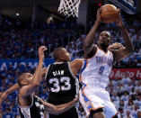 OKLAHOMA CITY, OK - JUNE 02: Serge Ibaka #9 of the Oklahoma City Thunder goes up for a shot against Tim Duncan #21 and Boris Diaw #33 of the San Antonio Spurs in the first quarter in Game Four of the Western Conference Finals of the 2012 NBA Playoffs at Chesapeake Energy Arena on June 2, 2012 in Oklahoma City, Oklahoma. NOTE TO USER: User expressly acknowledges and agrees that, by downloading and or using this photograph, User is consenting to the terms and conditions of the Getty Images License Agreement. (Photo by Brett Deering/Getty Images)
