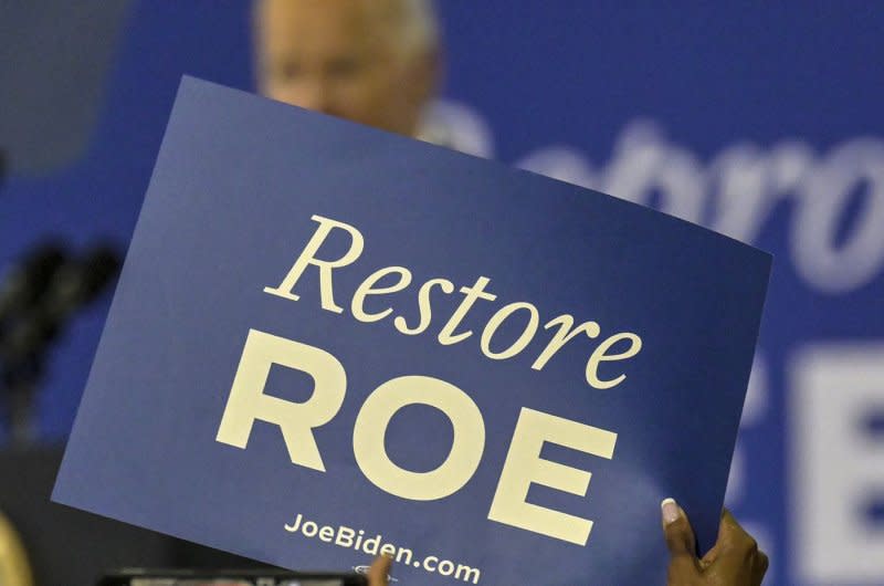 A sign that reads "Restore Roe" is seen at a rally by President Joe Biden in Florida. Advocates in South Dakota were aiming to put a measure on November's ballot to codify abortion protections established in Roe vs. Wade in the state's constitution. Photo by Steve Nesius/UPI