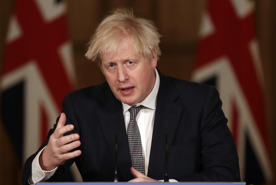 Britain's Prime Minister Boris Johnson speaks during a news conference on the ongoing situation with the coronavirus pandemic, inside 10 Downing Street in London, Wednesday, Dec. 16, 2020. (AP Photo/Matt Dunham, Pool)