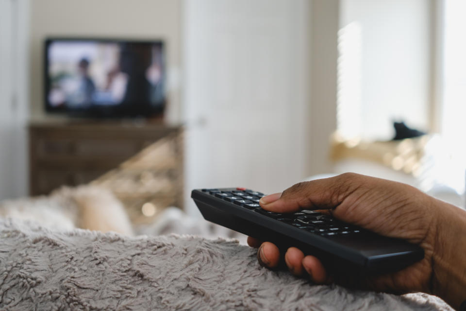 person holding tv remote watching tv, amazon fire tv stick, person holding tv streaming stick watching tv