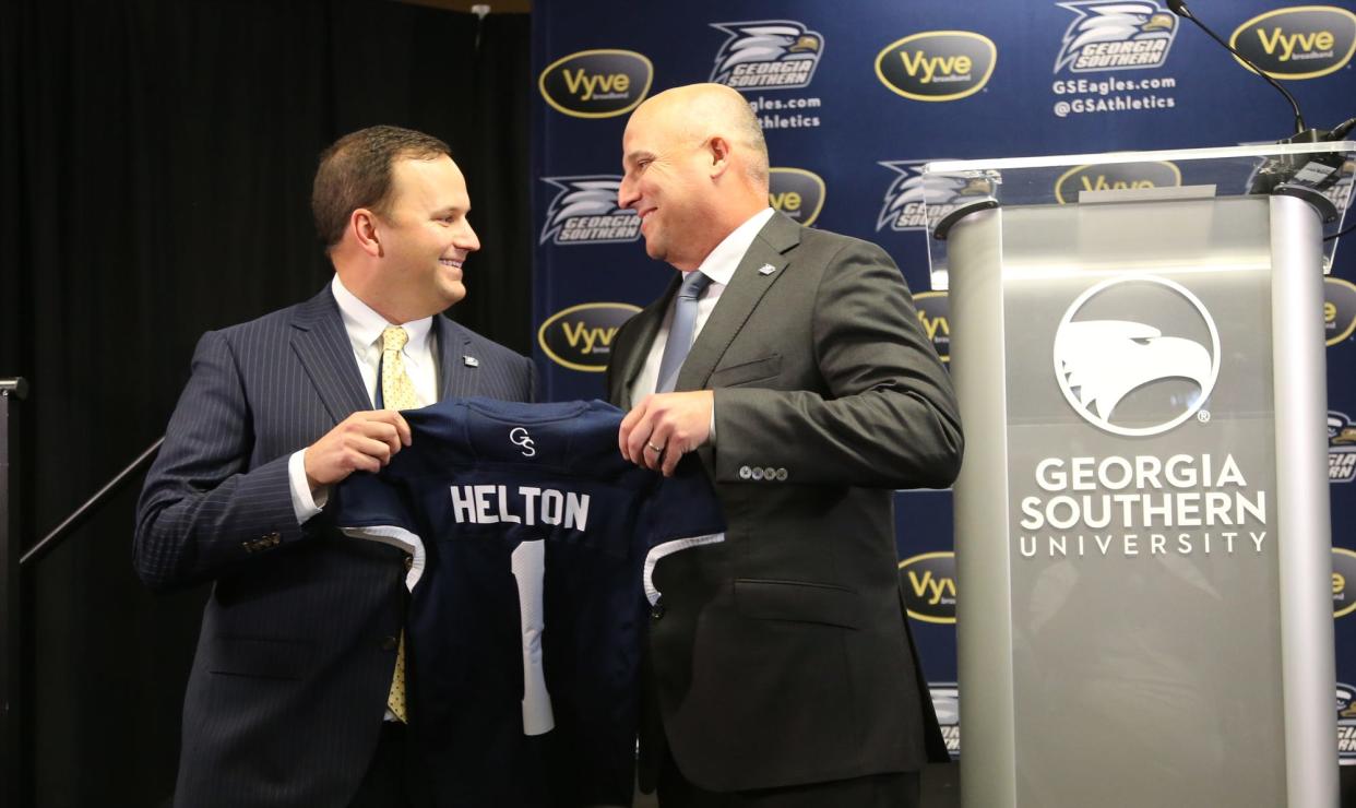 Georgia Southern Director of Athletics Jared Benko, left, presents new head football coach Clay Helton with a jersey on Nov. 4, 2021 at Bishop Field House in Statesboro.