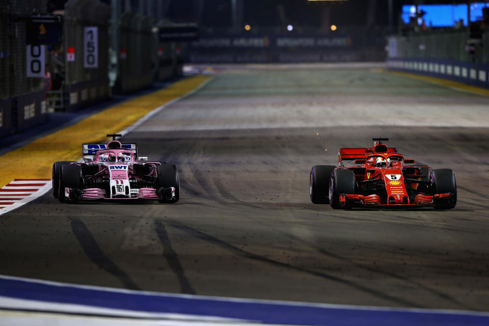 SINGAPORE - SEPTEMBER 16:  Sergio Perez of Mexico driving the (11) Sahara Force India F1 Team VJM11 Mercedes and Sebastian Vettel of Germany driving the (5) Scuderia Ferrari SF71H on track during the Formula One Grand Prix of Singapore at Marina Bay Street Circuit on September 16, 2018 in Singapore.  (Photo by Charles Coates/Getty Images)